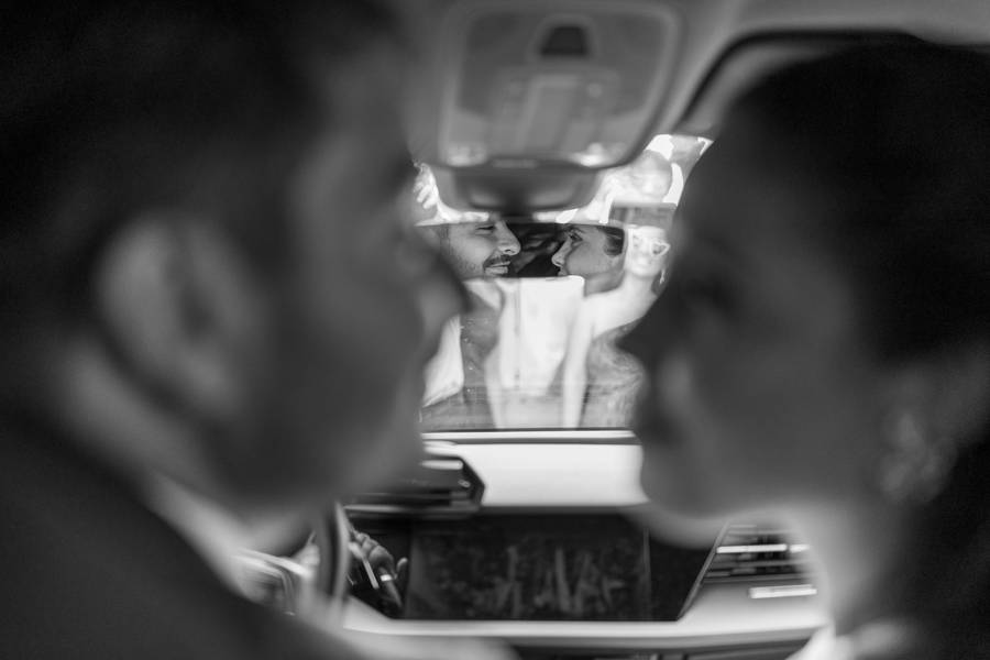 Couple reflected in the car on the way to the party — wedding in Lisbon