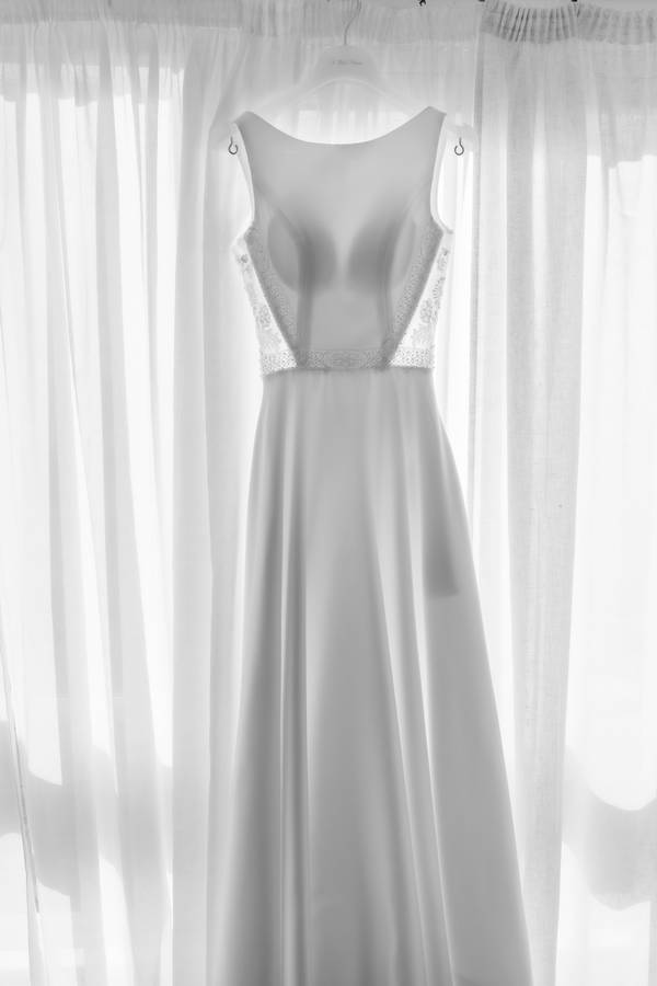 Wedding dress hanging by the window — wedding in Lisbon