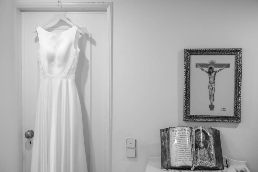 Wedding dress hanging beside a crucifix — wedding in Lisbon