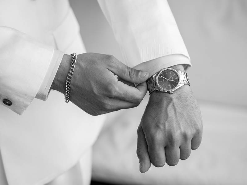 Groom putting on his watch — wedding in Comporta