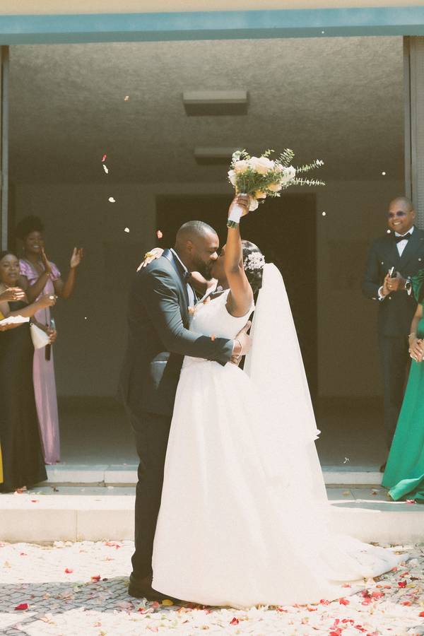 Couple celebrating as they leave the ceremony — wedding in Lisbon