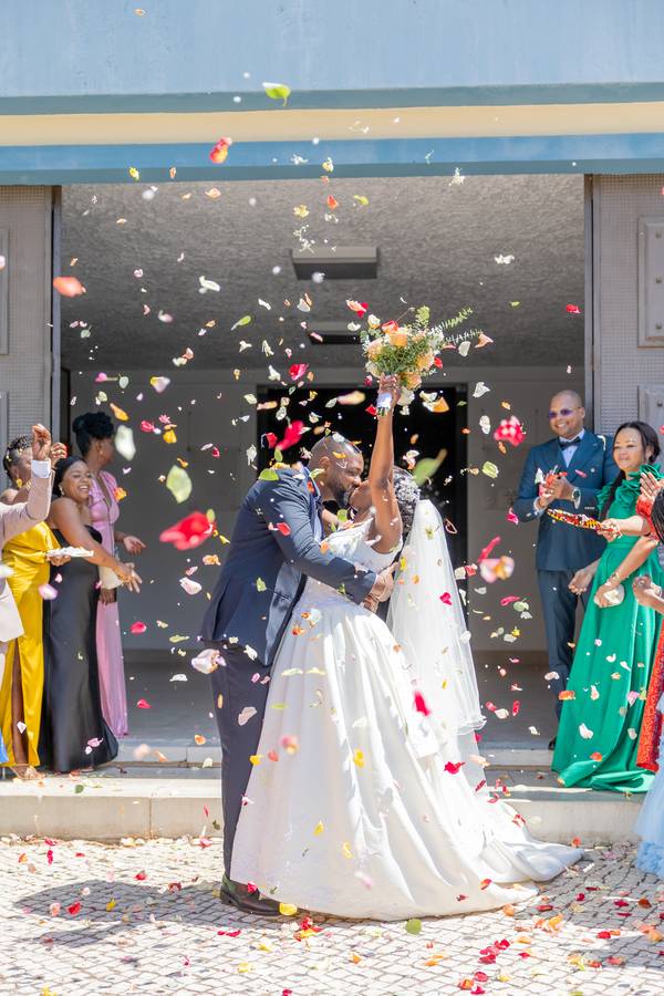 Couple leaving among flower petals — wedding in Lisbon